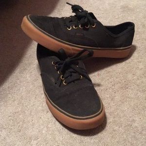 Black and gold Vans.